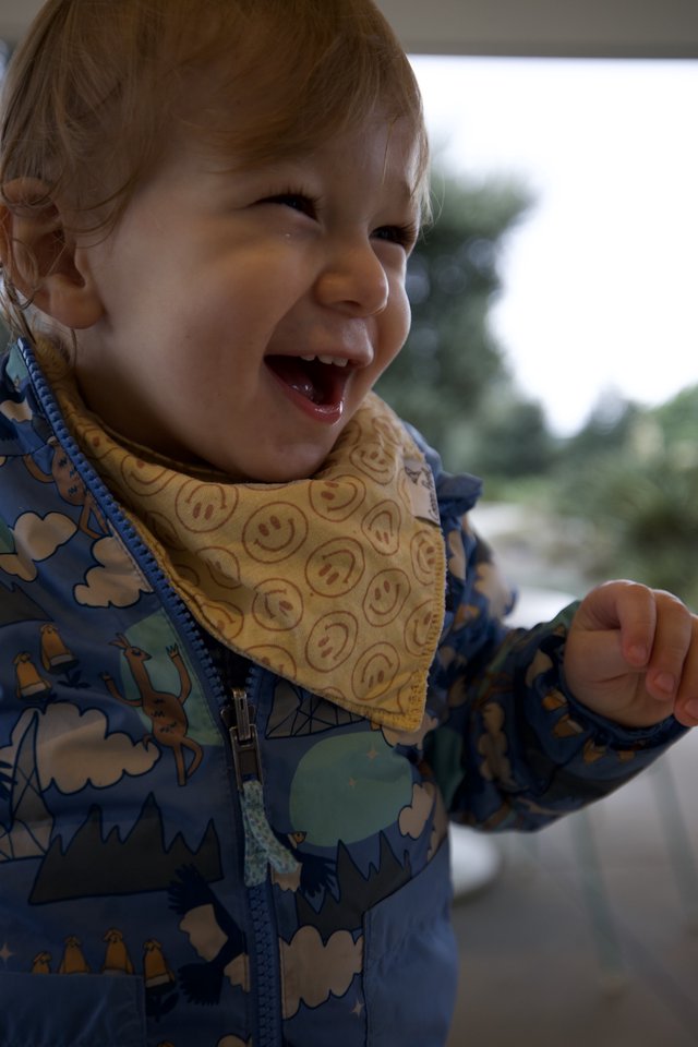 Joyful Toddler in Winter Jacket Outdoors