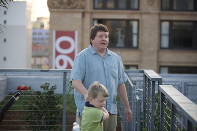 Father and Son on Urban Rooftop Terrace
