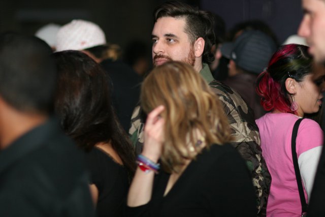 A Pink-haired Bearded Man in a Club