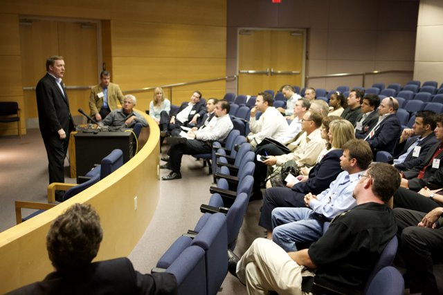 Speaker addressing a crowded auditorium