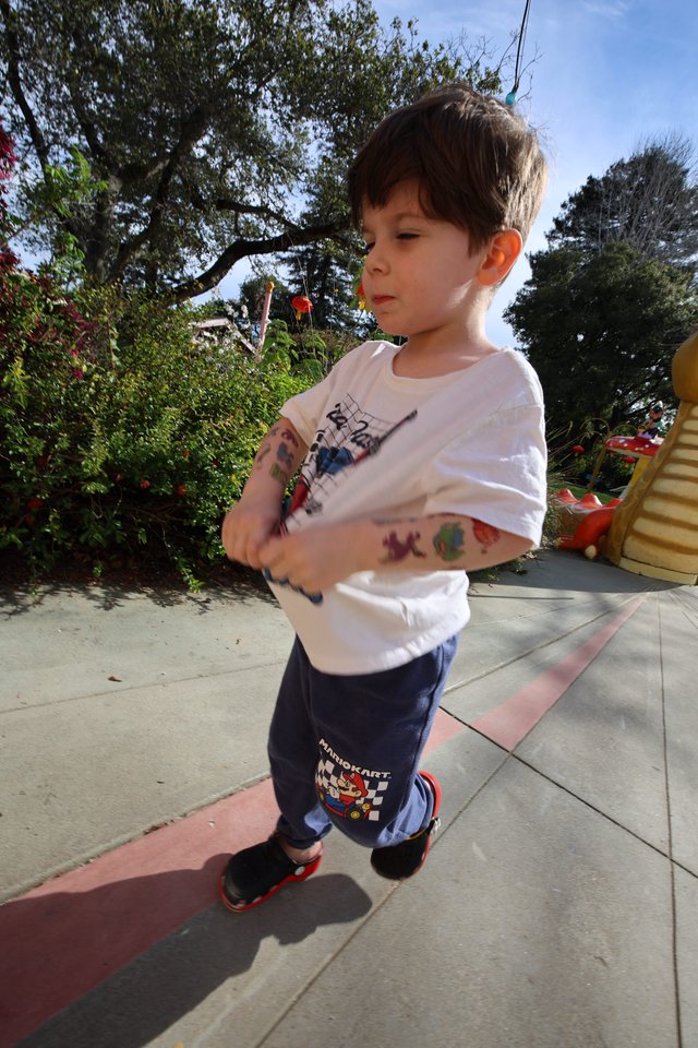 Young Boy with Temporary Tattoos at Outdoor Playground