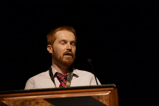 Red-bearded Man Addresses a Crowd