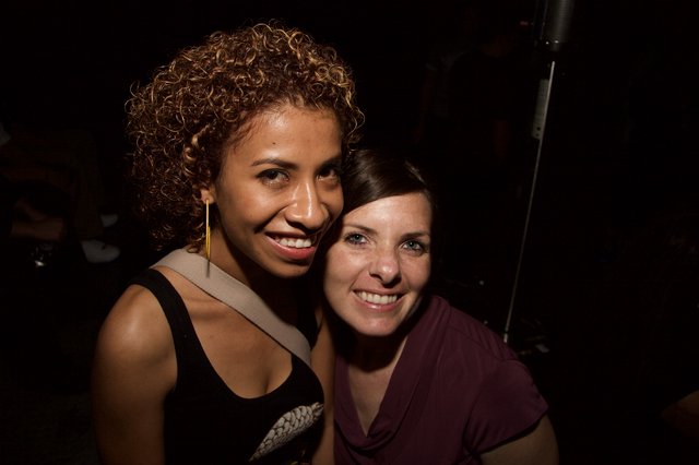 Two Friends Smiling Together at a Nightclub Event