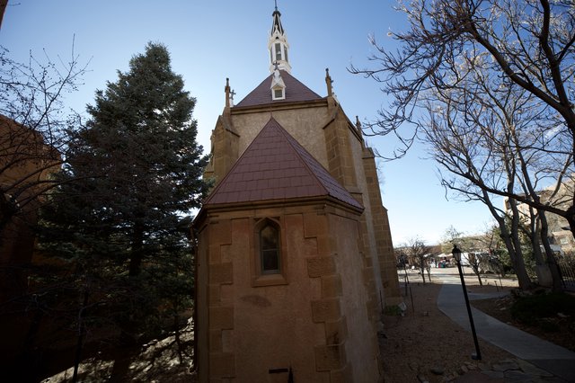 Historic Stone Chapel with Purple Roof and Bell Tower