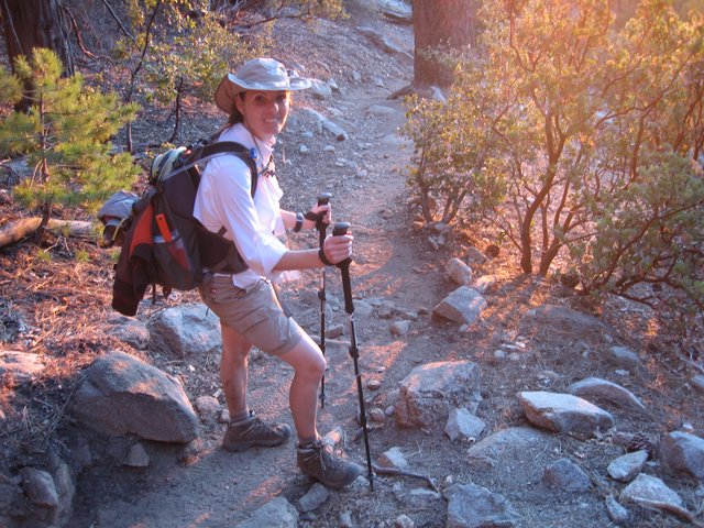 Smiling Hiker on Rocky Mountain Trail at Sunset