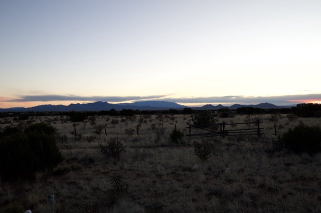 Desert Twilight Over Distant Mountain Ranges