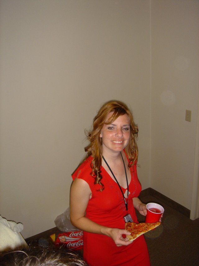 Young Woman Enjoying Pizza and Soda at Party