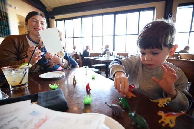Mother and Child Playing with Toys at Restaurant