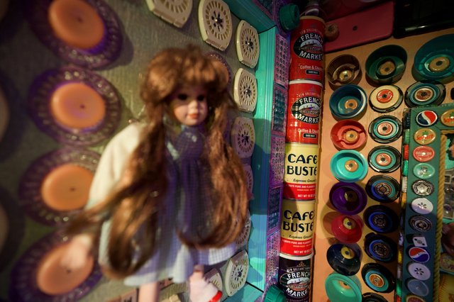 Vintage Doll Among Colorful Button Collection Display