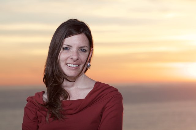 Smiling Woman in Red at Golden Sunset
