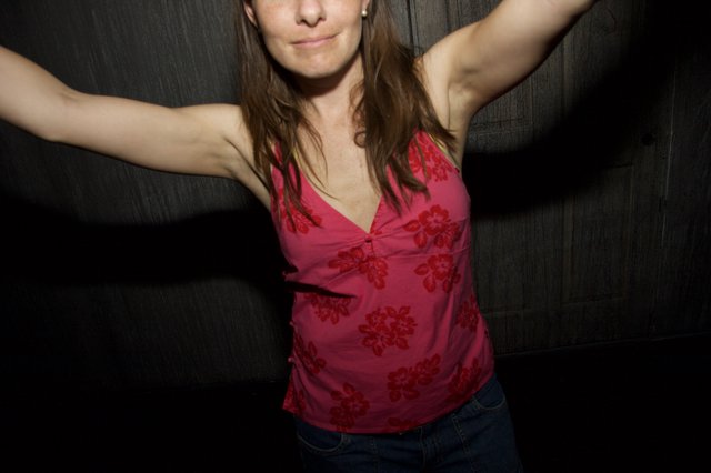 Woman Dancing Freely With Arms Outstretched at Night
