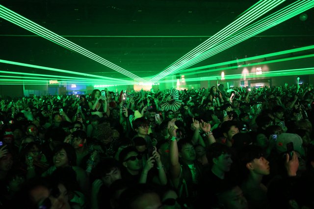 Green Laser Light Show Over Festival Dance Crowd