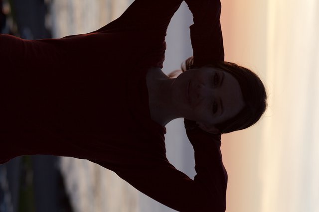 Silhouetted Woman at Golden Hour by the Sea