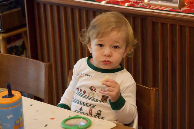 Toddler Enjoying Christmas Eve Snack at Home