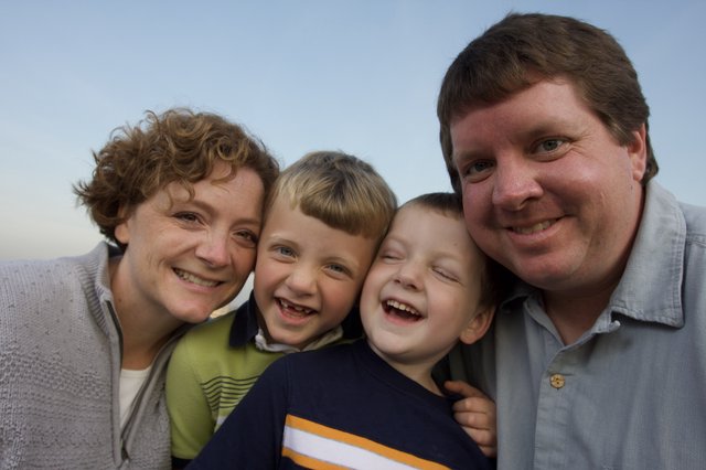 Joyful Family of Four Smiling Outdoors Together