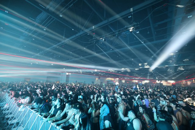 Massive Indoor EDM Festival Crowd Under Laser Light Show
