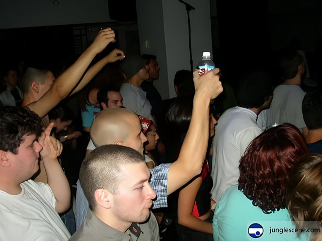 Partygoers at Nightclub with Water Bottle
