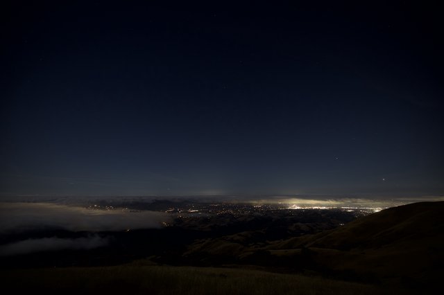 City Lights Glowing Beneath a Sea of Fog