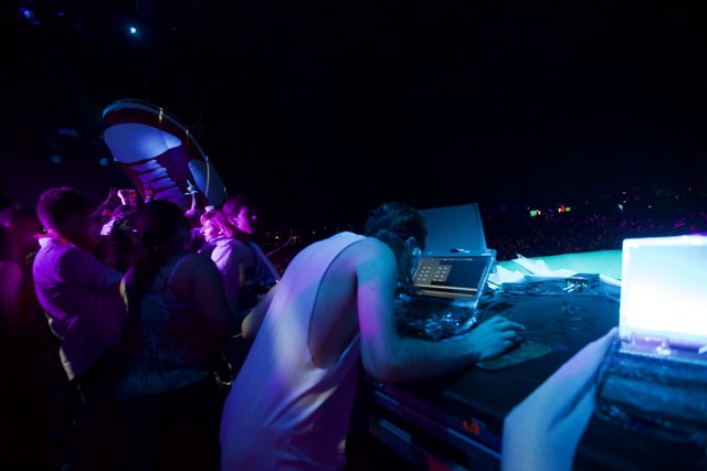 DJ with Laptops and Nightclub Lights