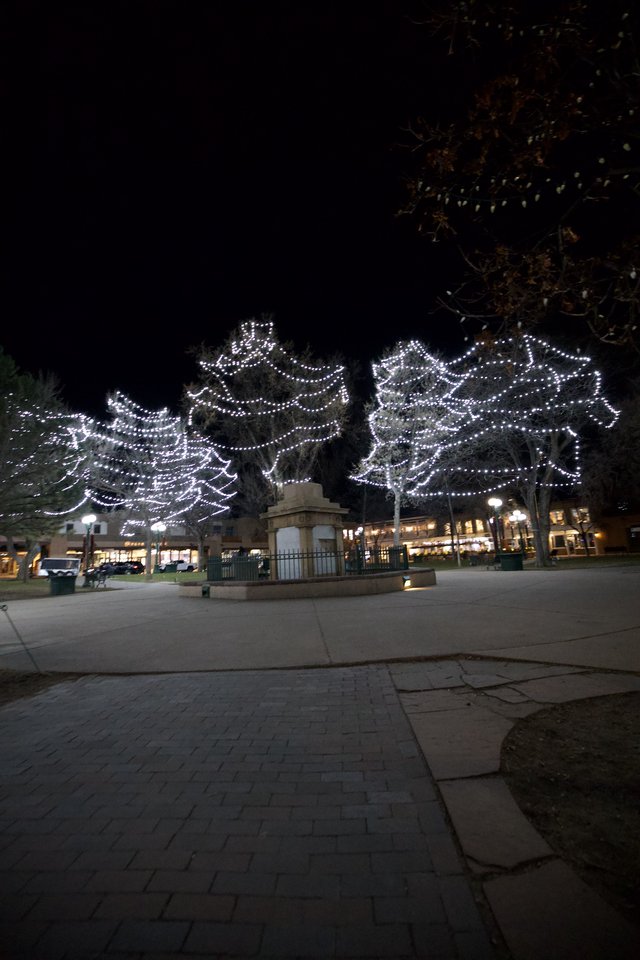 Illuminated Angel Wings Display in Town Square at Night