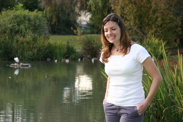 Smiling Woman by a Serene Park Pond