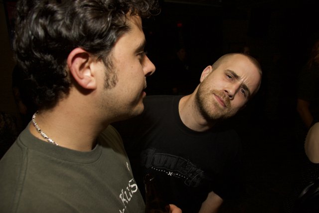 Two Men in T-Shirts at a Night Club