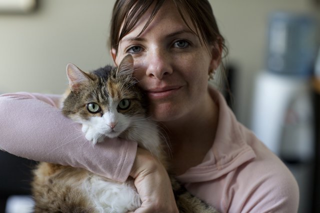 Woman and Calico Cat Share a Tender Moment