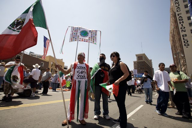 Man Proudly Holds Mexican Flag at Mayday Rally