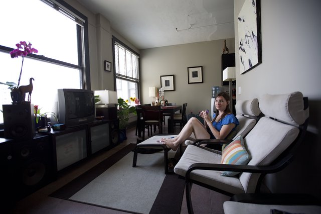 Woman Relaxing in Urban Apartment on Independence Day