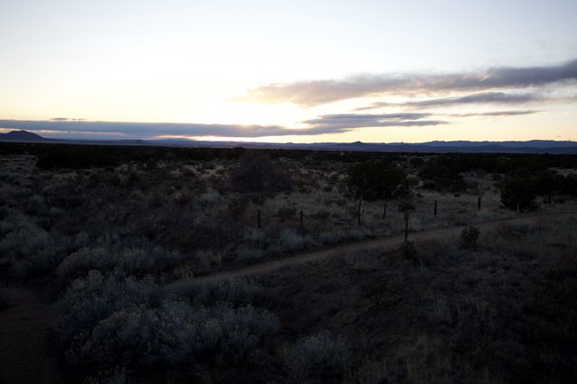 Desert Twilight Along a Fence-Lined Dirt Road
