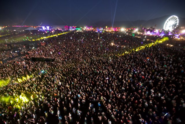 Electric Atmosphere: A Music Festival Crowd under the Night Sky