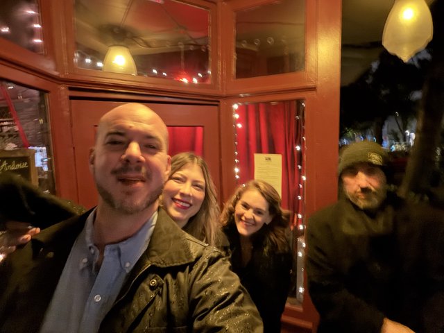 Friends Gathering at Cozy Restaurant Entrance