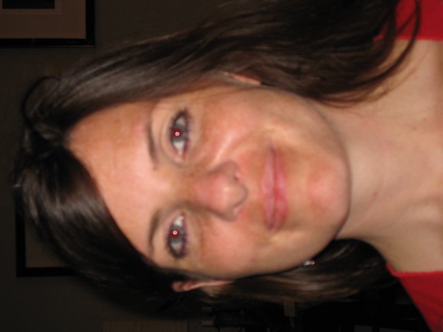 Smiling Woman with Red-Eye Effect in Warm Portrait