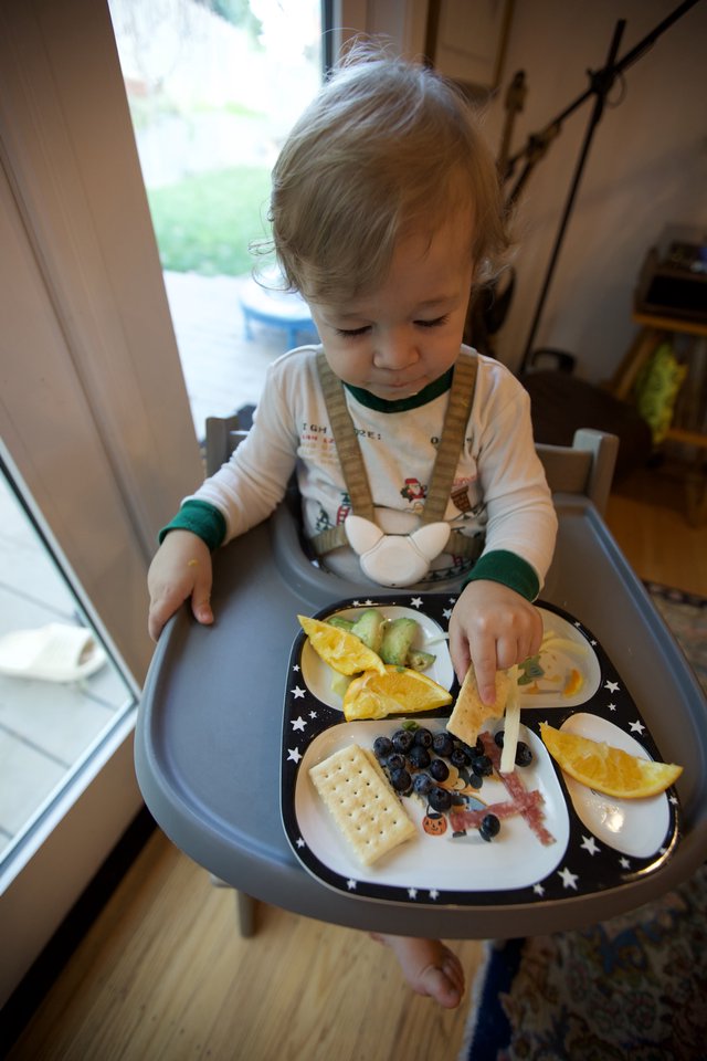 Toddler Enjoying Christmas Eve Breakfast at Home