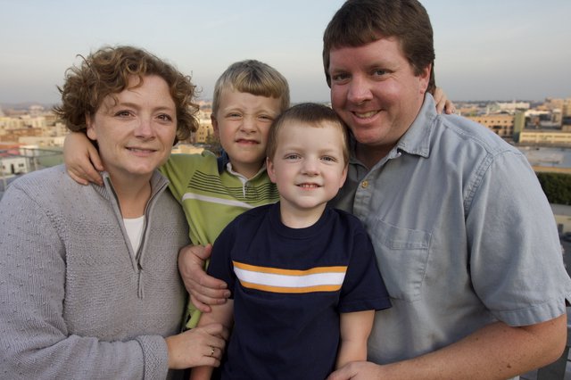 Happy Family Portrait on Rooftop at Dusk