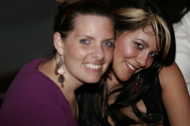 Two Smiling Women Posing Together at Night Event