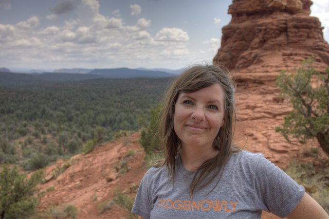 Woman Smiling Atop Sedona Red Rock Formation