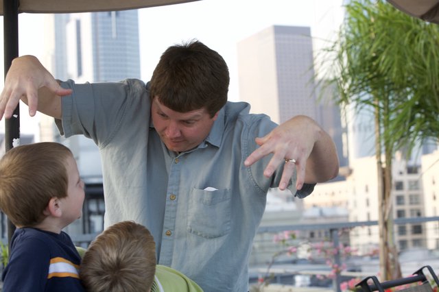 Father Entertains Kids with Animated Storytelling Outdoors