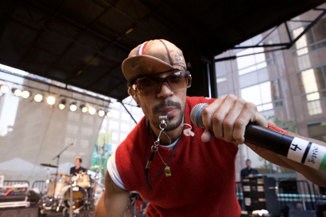 Red Shirted Man Rocks the Mic at Ozomatli Concert