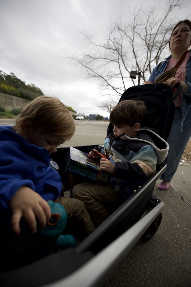 Children Reading in Wagon During Overcast Day Outing