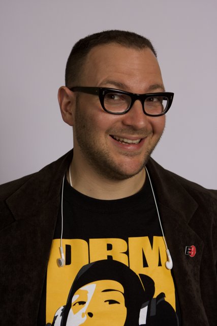 Smiling man in glasses and black jacket