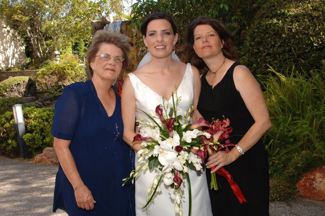 Bride Poses with Family at Garden Wedding