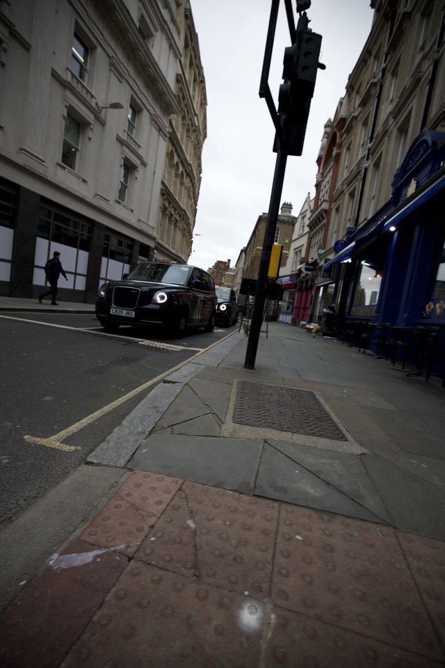 Low Angle Street View of London with Black Cab