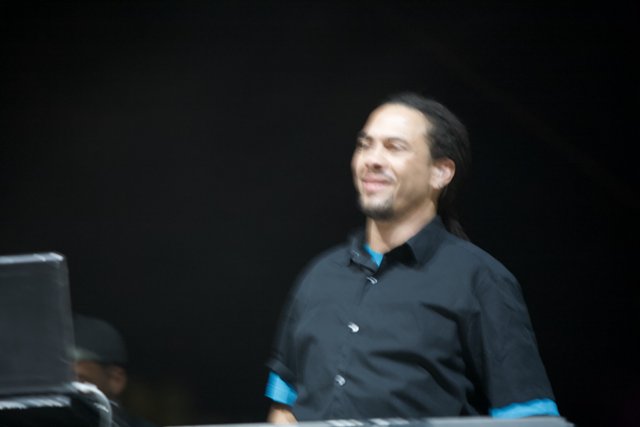 Roni Size Smiling for the Camera in Black Shirt