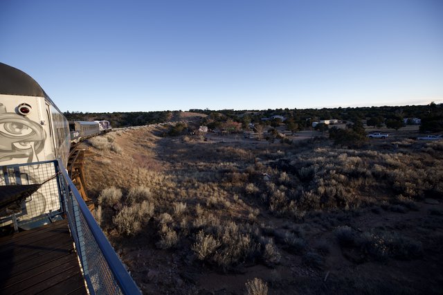 Vintage Train Car Observation Deck Over Desert Landscape