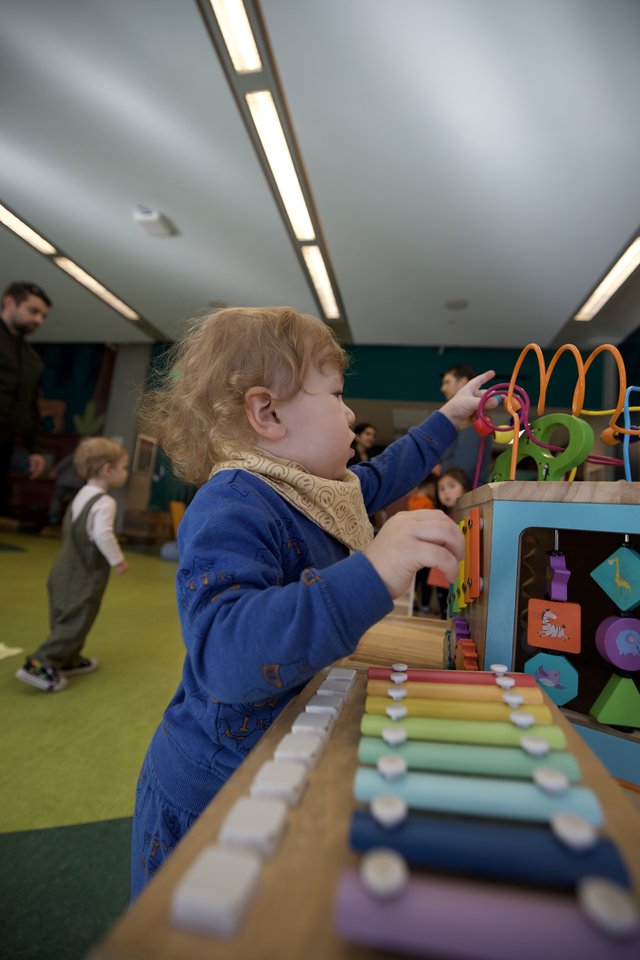 Toddler Engaged in Developmental Play at Activity Center