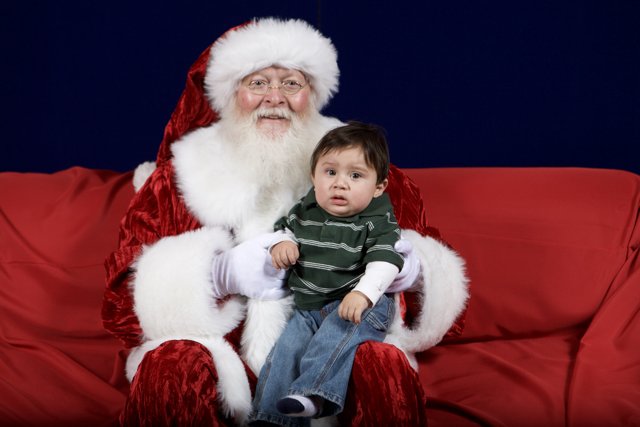 Santa Claus and Child on Red Couch