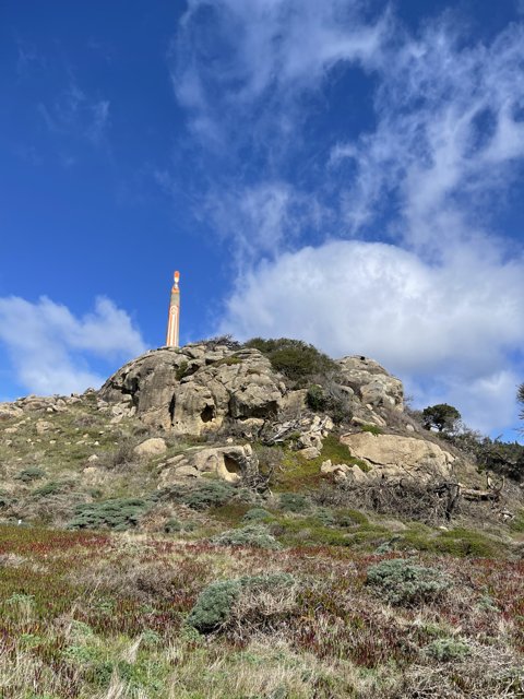 Majestic Lighthouse on Rocky Hillside