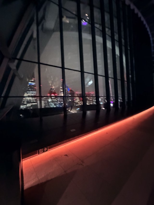 Night View of London Skyline Through Modern Glass Architecture