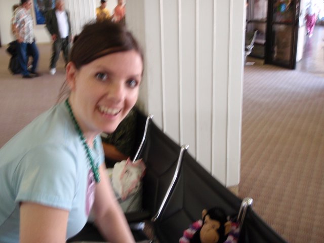 Smiling Woman With Stroller at Indoor Event